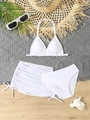 Flat lay of white three-piece girls bikini set with drawstring skirt and summer accessories - Ivory
