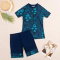 Flat lay of boys' two-piece swimsuit with tropical palm leaves and front zipper top - S / Blue Leaves