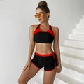 Close-up of two-piece sports bikini featuring black zipper top and red contrast trim details - S / Red