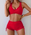 Detail of red two-piece bikini featuring wrap top and high-waisted drawstring swim shorts - S / Red