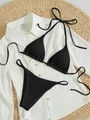 Black ribbed bikini set with halter triangle top and high-cut thong on woven straw mat - Black