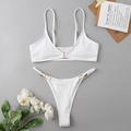 Detail of white rib-knit bikini with gold rectangle hardware on a minimalist background - White
