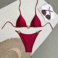 Detail of burgundy bikini set featuring gold swirl metal buckles and high-leg cut style - S / Red