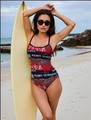 One-piece swimsuit for women with red and black letter print standing on a beach - S / Rainbow