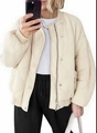 Detail of off-white quilted bomber jacket showing wave stitching and ribbed trims - S / Apricot