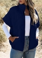 Detail of navy blue quilted vest showing diamond pattern and functional pockets - Navy Blue