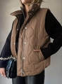 Detailed view of women's brown quilted vest featuring stylish wave pattern and zipper closure - Dark Khaki