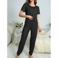 Women's black two-piece pajama set featuring short sleeves and drawstring jogger pants - S / Black