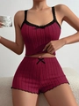 Macro detail of wine red ribbed fabric pajama set with delicate black lace trim and bow - Burgundy