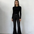 Detail view of vintage washed black high-waisted flare jeans and slim fit ribbed sweater - XS / Black