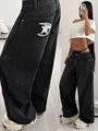 Nahaufnahme der Sternstickerei auf grauen Vintage-Jeans mit hohem Bund und weitem Bein - XS / Schwarzgrau