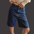 Women high waisted stretchy denim shorts in dark blue wash shown on model - S / Dark Blue