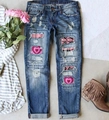 Detail of distressed denim jeans with pink heart patchwork and ripped accents - 3XL / Dark Pink Heart Print