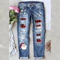 Women's blue denim jeans with ripped plaid patches and festive Santa Claus print - S / Blue With Red Plaid Patches And Christmas Print