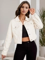 Close-up of cream cropped denim jacket featuring metal buttons and front flap pockets - XS / Beige Apricot