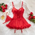 Detail of red lace lingerie set with sequins, cross-strap corset, and ruffled mesh skirt - S / Red