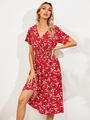 Close-up of deep V-neck and elastic waist detail on a red floral summer dress - S / Red