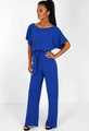 Close-up of royal blue jumpsuit showing ruffle short sleeves and self-tie bow waist detail - S / Blue