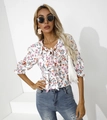 Close-up of floral chiffon blouse with bow neckline and delicate ruffle sleeve details - S / White