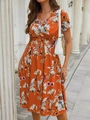 Detail of V-neck summer dress featuring orange floral print and elastic waist design - S / Orange