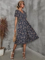 Detail view of navy blue floral dress featuring V-neck and smocked elastic waist design - S / Blue