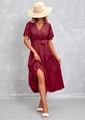Detail view of burgundy wrap dress featuring a v-neckline and layered ruffle skirt - S / Fuschia
