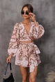 Detail of pink floral two-piece set featuring V-neck long sleeve top and tie-waist shorts - Pink