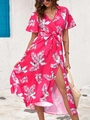 Detail of fuchsia summer wrap dress featuring white leaf print and a side high slit design - Rose Red