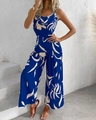 Detail of blue floral jumpsuit featuring a cowl neck and wide leg fit in a resort style - S / Top And Bottom / Blue