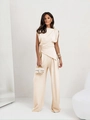 Detail view of beige high-waist wide-leg trousers with elegant drape and minimalist style - S / Apricot