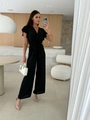 Detail view of the black V-neck jumpsuit featuring ruffle sleeves and a waist-tie design - S / Top And Bottom / Black