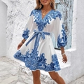 Boho V-neck paisley print mini dress with long puff sleeves and belted waist on model - White with Blue Flowers
