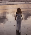 Close-up of elegant off-shoulder white mesh maxi dress on a sunset beach setting - S / White