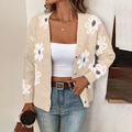 Detailed view of 3D knit white daisy flowers on a beige button-up cardigan sweater - S / Apricot