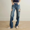 Detailopname van high-waist jeans met ronde uitsparingen en gewassen denimtextuur op de pijp - M / Blauw