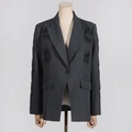 Detailed view of dark grey blazer featuring architectural pleats and single-button closure - S / Gray