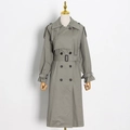 Detail of sage green trench coat featuring double-breasted buttons and classic waist belt - XS / Gray