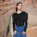 Detail view of stylish long sleeve top featuring a large textured black bow decoration - S / Black