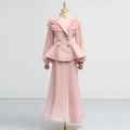Detail of light pink two-piece set featuring ruffled blazer top and pleated maxi skirt - Pink