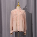 Detailed view of the 3D floral ruffles and light chiffon fabric on the pink long sleeve shirt - XS / Pink