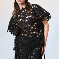 Detail view of black laser-cut hollow flower design on a high-fashion designer top - S / Black