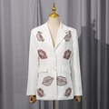 Close-up of white blazer jacket featuring red and silver rhinestone lip embellishments - M / White