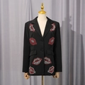 Detail of red rhinestone lip embroidery on a professional black tailored blazer - M / Black
