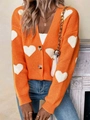 Detail of V-neck knitted cardigan featuring white heart patterns and brown buttons - S / Orange Red