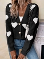 Detalle de cárdigan de punto negro con patrones de corazones blancos y puños elásticos - Negro