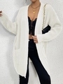 Close-up of white chunky knit cardigan featuring vertical texture and front pockets - White