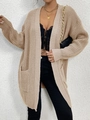 Close-up of beige knit cardigan texture and large front pockets for a stylish winter look - Khaki