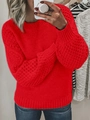 Detail of red cable-knit sweater featuring puffy lantern sleeves and ribbed cuffs - Red