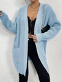 Close-up of light blue chunky knit cardigan texture with functional front pocket - Blue