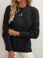 Detail eines schwarzen langärmeligen Strickpullovers mit Wellenstruktur und Rippbündchen - S / Schwarz